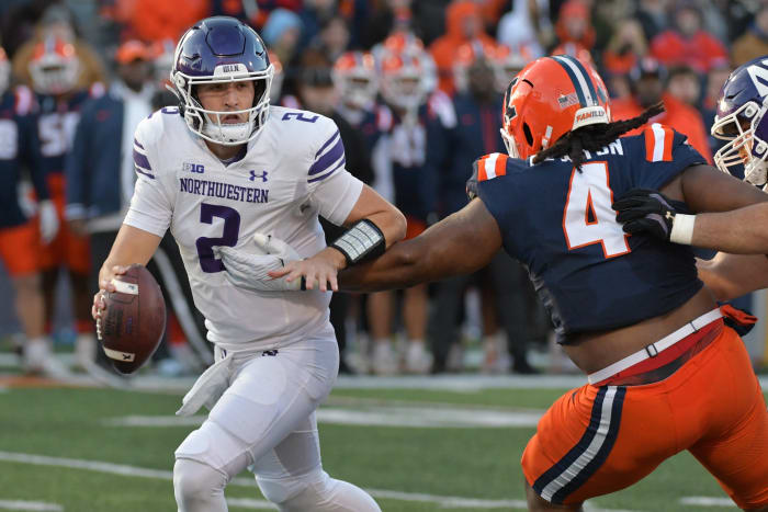 Nov 25, 2023; Champaign, Illinois, USA; Illinois Fighting Illini defensive tackle Jer'Zhan Newton (4) sacks Northwestern Wildcats quarterback Ben Bryant (2) during the first half at Memorial Stadium.